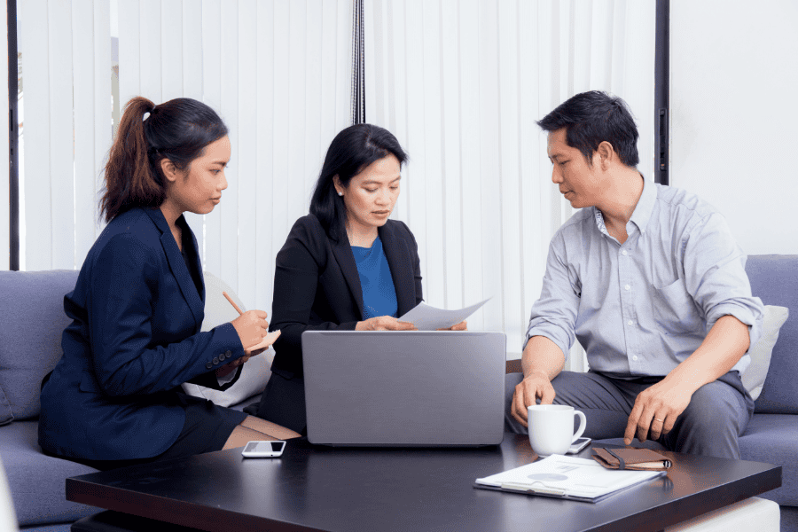 Business professionals discussing global market strategies in a modern office.