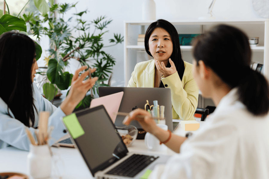 Business women discussing strategies in a modern office setting.