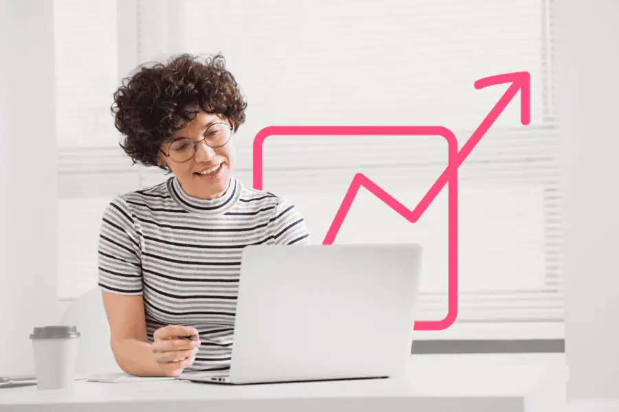 Young woman analyzing business growth data on laptop with upward arrow graph.