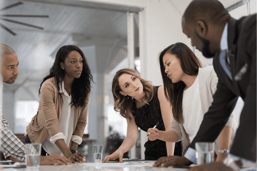 Diverse team discussing international market strategies in a modern office.