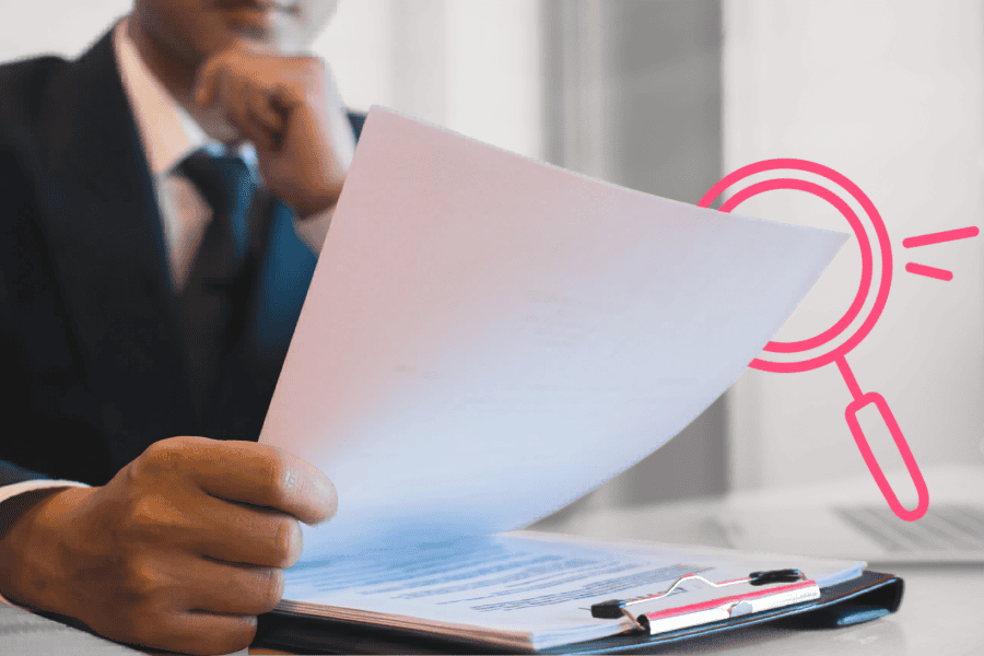 Business professional reviewing documents with a magnifying glass icon overlay.