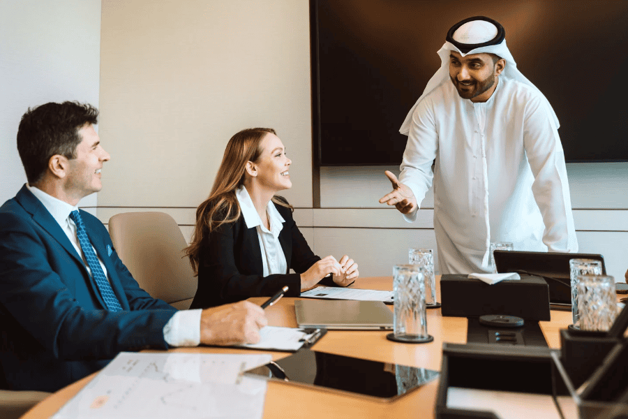 Business professionals discuss in a modern conference room.