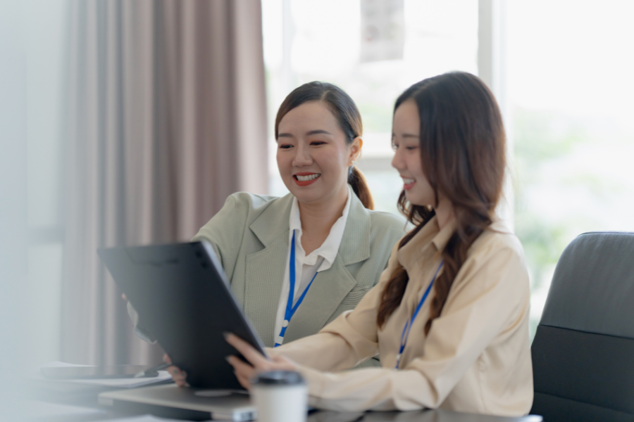 Two professional women looking at a document together