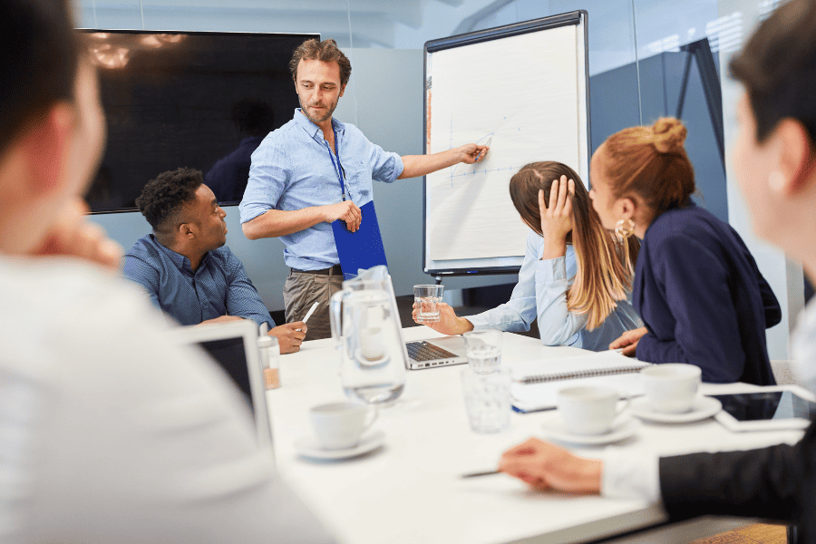 Team discussing HR strategies in a corporate meeting room.